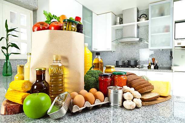 Organised grocery bags and fresh vegetables on a kitchen bench